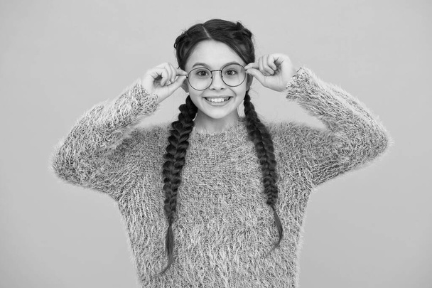 focus on what matters. cheerful teen has bad sight. Hair braided in braids. little beauty in glasses. happy childhood. small girl has nice smile. kid hairstyle fashion. smiling child with long hairdo - Foto, afbeelding