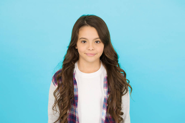 Fashion shop. Shopping day. Feeling cool. Cute girl with long hair. Small girl checkered shirt. Happy international childrens day. Little girl turquoise background. Good mood concept. Positive vibes - Foto, afbeelding