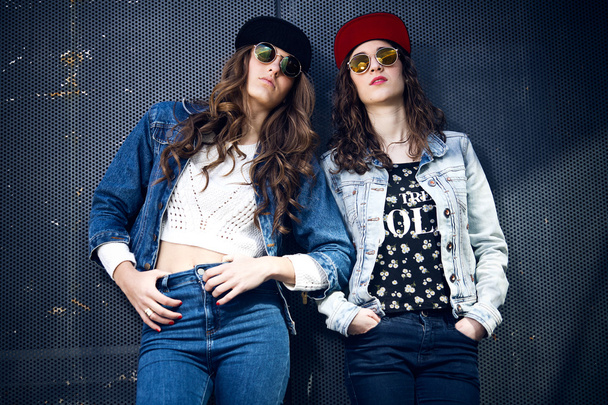 young beautiful girls with denim suit in a urban background - Fotoğraf, Görsel