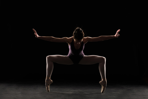 Silhouette ballet dancer in black swimsuit - Photo, Image