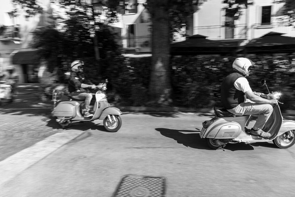 PESCANTINA, VERONA, ITALY, JUNE 23, 2019: motorcyclist driving his wasp, national gathering of the Vespa motorcycle - Фото, изображение