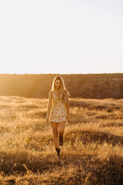 portrait of beautiful blonde woman on nature during sunset - Foto, Imagen