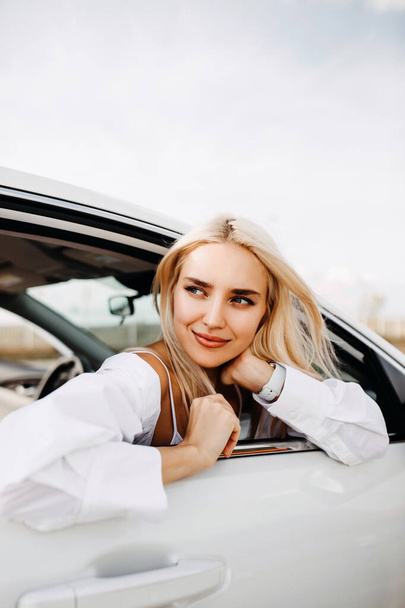 beautiful young woman looking out of car - Fotó, kép