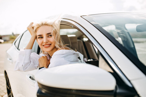 beautiful young woman looking out of car - Photo, image