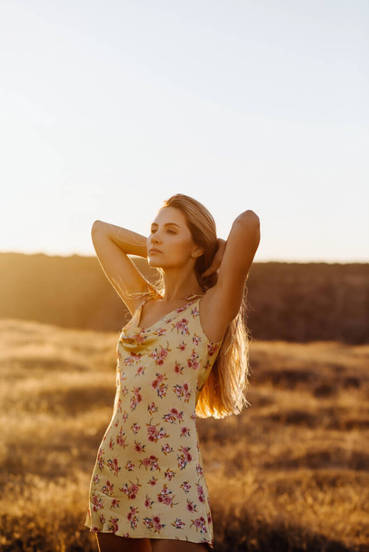 portrait of beautiful blonde woman on nature during sunset - Foto, imagen