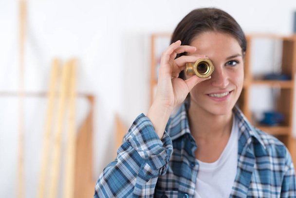 girl looking through a screw - Valokuva, kuva
