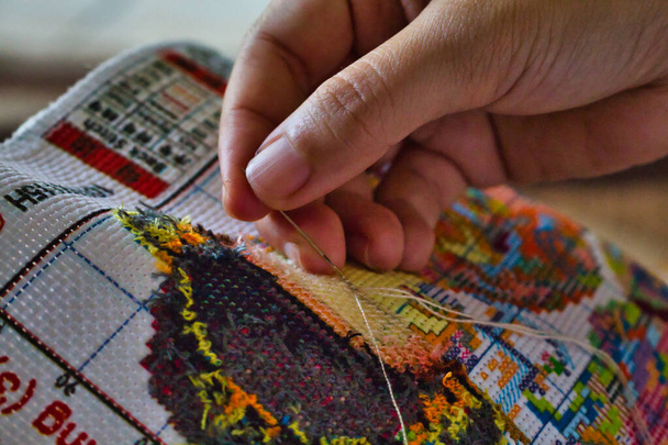 A person embroidering cute Asian cartoons - Zdjęcie, obraz