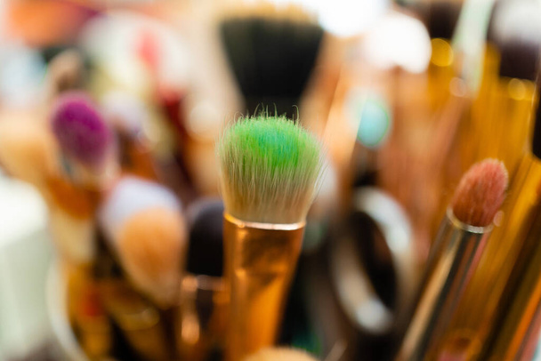 A macro shot of different makeup brushes in a cup - Foto, Bild