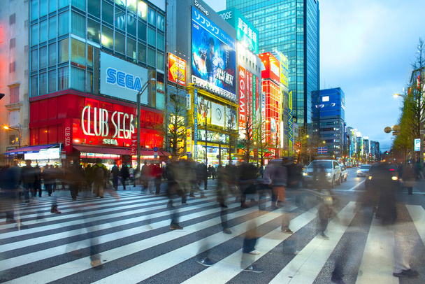 Akihabara Electric Town, Tokyo, Kanto Region, Honshu, Japan - Motion blur of people at a street crossing in the bustling district of  Akihabara Electric Town. - Photo, Image