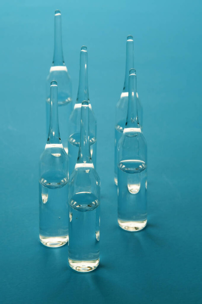 Medicine ampoules for injections on blue surface - Foto, Imagen
