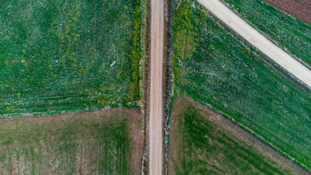 An aerial shot of dirt roads in an agricultural landscape - Fotó, kép