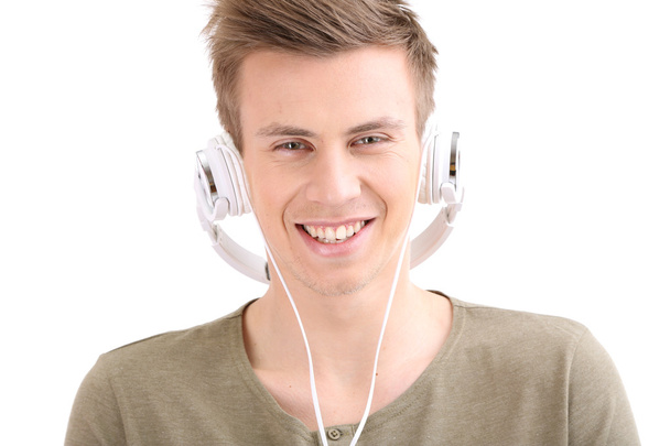 Handsome young man listening to music isolated on white - Φωτογραφία, εικόνα