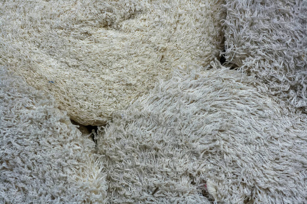 Rolls with rags close-up. Light textile material with a long pile. - Photo, Image