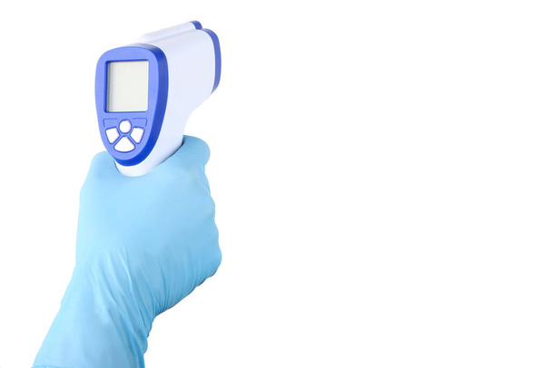 Medical infrared thermometer in doctor hand isolated on white background - Foto, afbeelding