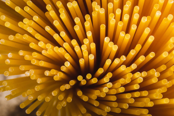close up of yellow long spaghetti. Yellow italian pasta. Raw spaghetti. Food background concept. - Φωτογραφία, εικόνα