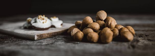 Organic walnuts and cookies wooden background - Photo, Image
