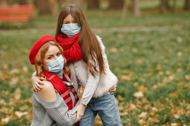 Mother with daughter walks outside in masks - Фото, зображення