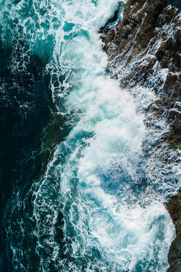 Sea waves breaking against the rocks - 写真・画像