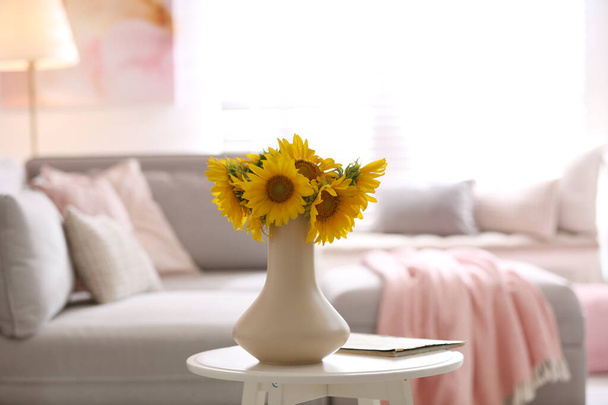 Beautiful bouquet of sunflowers in vase on white table indoors - Foto, immagini