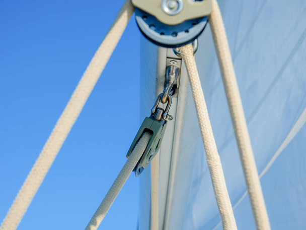 A soft focus of ropes and hooks and travelers attached to boom - Photo, image