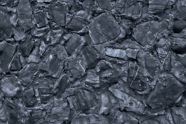 Abstrakter Hintergrund vieler großer Steine. Leere Steinoberfläche mit neutraler Farbe.  - Foto, Bild