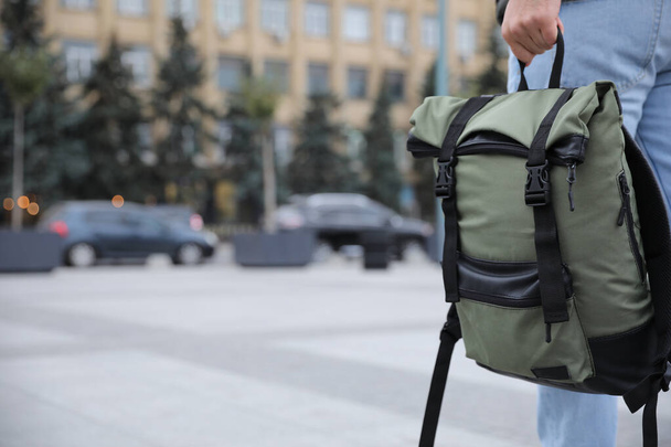 Male tourist with travel backpack on city street, closeup. Urban trip - Фото, зображення