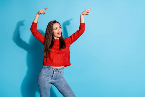 Photo of energetic girl point index finger copyspace wear jumper isolated over blue color background - Valokuva, kuva