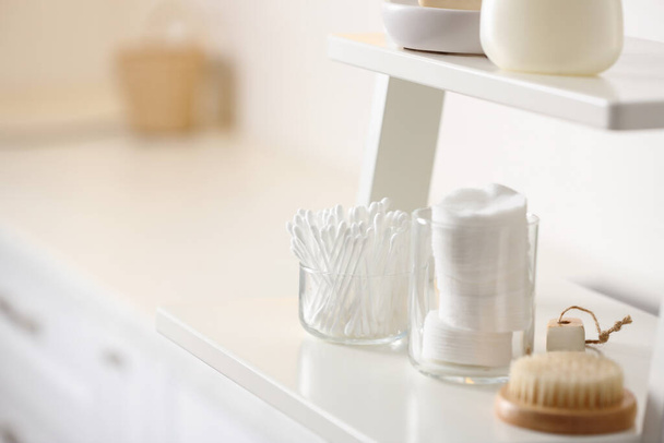 Cotton buds and pads on shelf in bathroom, space for text - Foto, Imagen