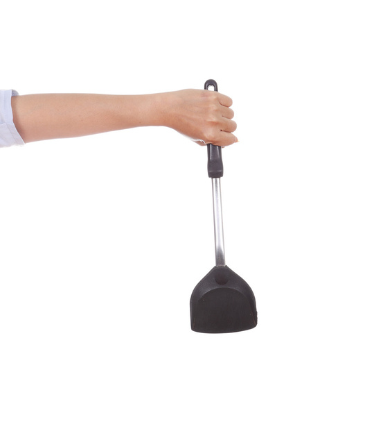 woman hand holding a kitchen spatula - 写真・画像