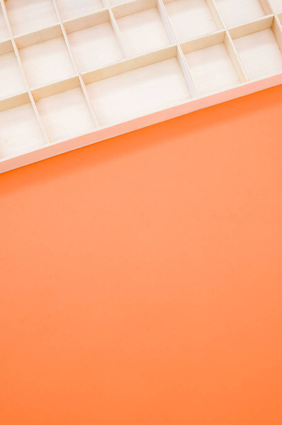 A top view closeup of an acrylic paint storage box isolated on an orange background - 写真・画像