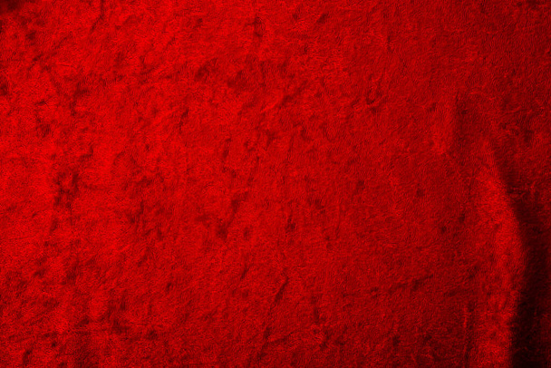 Abstract background and luxury cloth concept with red velvet fabric, mostly stretched but with a couple of  folds or creases with plenty of copy space for text - Photo, Image