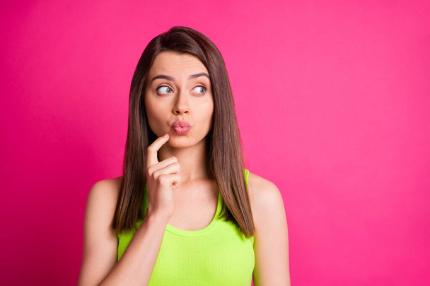 Photo of lovely funny girl finger face lips look side empty space wear green singlet isolated bright pink color background - Φωτογραφία, εικόνα