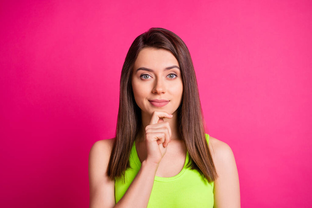 Photo of pretty pensive girl arm chin think look camera wear green top isolated vibrant pink color background - Fotó, kép