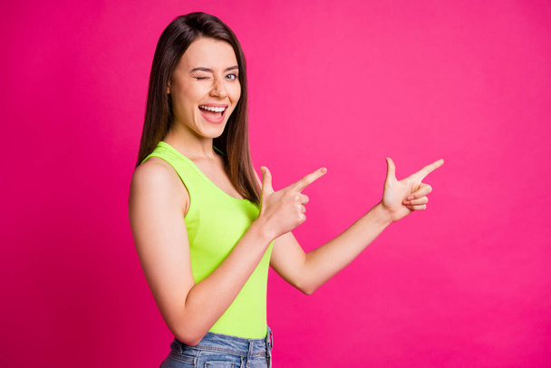 Profile photo of funky coquette girl direct fingers empty space close eye wear green top isolated vivid pink color background - Fotoğraf, Görsel