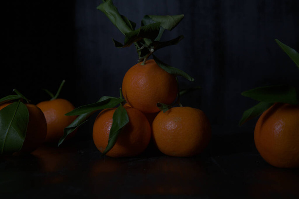 Tangerines on a black surface - Foto, Imagen