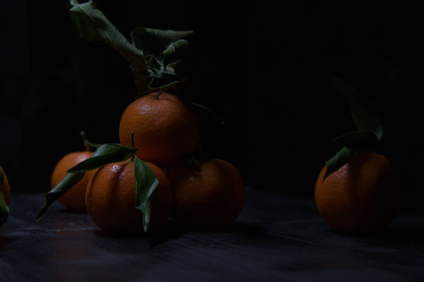 Tangerines on a black surface - Fotografie, Obrázek