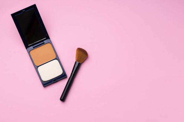 Make up palette with brush on pink background - Фото, изображение