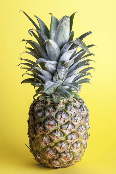Whole pineapple on yellow background - Foto, immagini