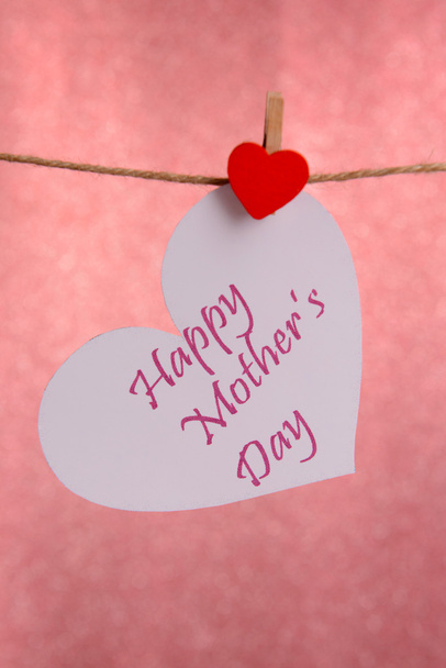 Happy Mothers Day message written on paper heart on pink background - Valokuva, kuva
