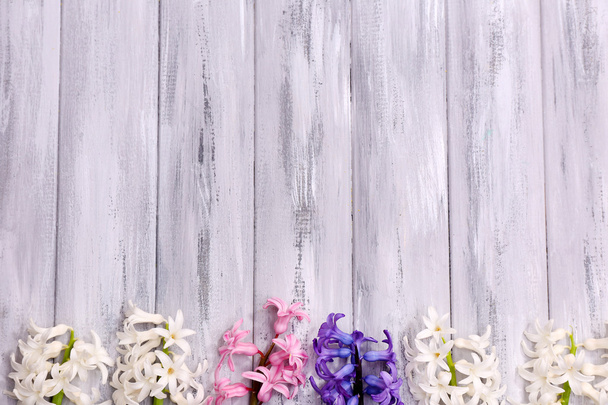 Beautiful hyacinths on color wooden background - Foto, immagini