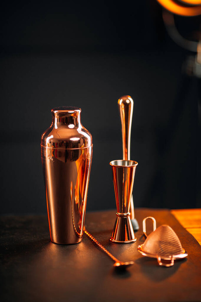 Copper bar tools set with shaker on wooden table - Fotografie, Obrázek
