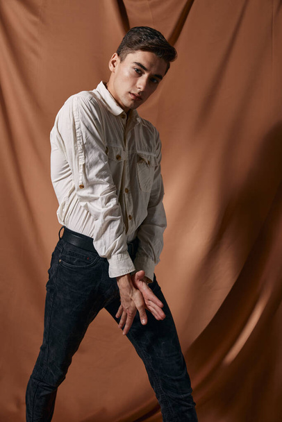 Man in white shirt posing fashion fabric background self confidence - Foto, Imagen
