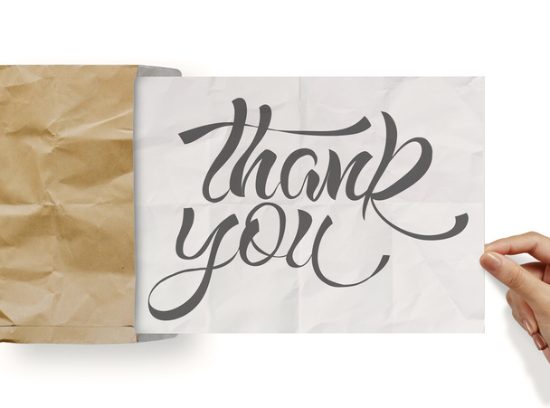 Geschäftsmann Hand zeigen Design Wort Danke auf zerknülltem Papier als - Foto, Bild