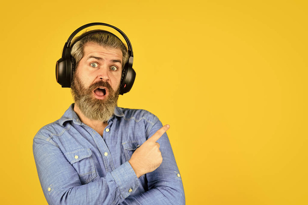 Popular music playlist. Music beat. Noise cancelling function. Dj hipster. Man bearded hipster headphones listening music. Singer on rehearsal. Hipster enjoy excellent sound song in earphones - Foto, Imagen