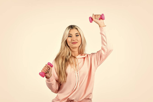 Pink is her favorite. Stay in shape. Daily exercising. Fitness girl lifting dumbbells. Healthy fitness woman doing exercises with dumbbells. Woman in sportswear holding dumbbells. Fitness equipment - Zdjęcie, obraz