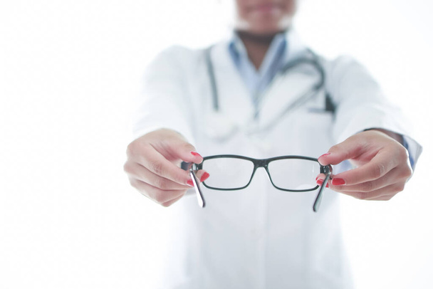 Optometrist holding a pair of glasses - Photo, Image