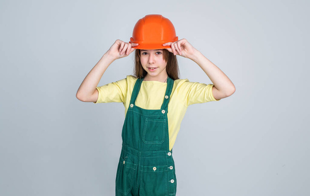 kid build construction. engineer teen is construction worker. international workers day. electrician is her career. girl in helmet plays builder. building and renovating. Building is her life - Foto, imagen
