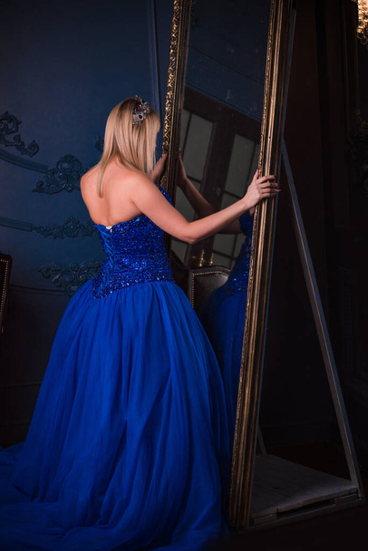 Woman in evening gorgeous blue dress. Pretty nice lady indoor. Woman in beautiful dressy  - Fotó, kép