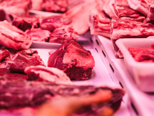 A closeup of raw meat in the shop window - Foto, afbeelding