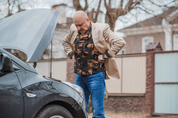 Senior man have a trouble automobile. Mature older man with a car problem, lifestyle - Zdjęcie, obraz